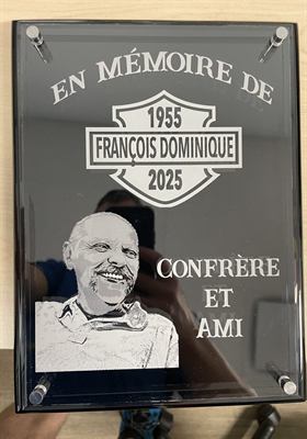 Plaque de verre fumé gravée d’un portrait et d’une dédicace commémorative, montée sur entretoises